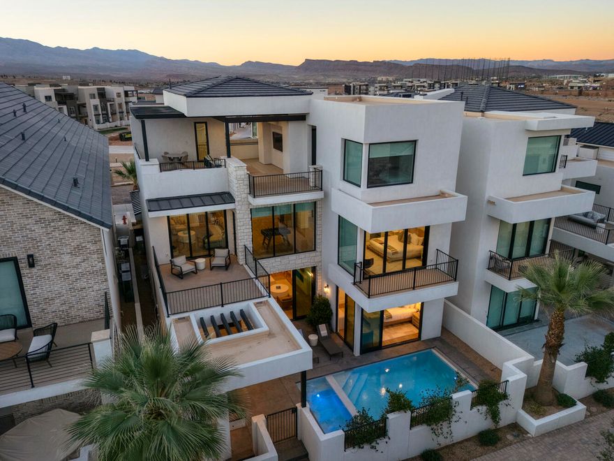 Elevated Luxury Living at this Desert Color Resort Oasis-Pura Sol! This stunning 3-story Split Rock home features 5 spacious bedrooms, effortlessly accommodating 18 guests in sheer comfort—no crowding! Enjoy your private patio with a pool, hot tub, outdoor bathroom and shower, barbeque, and ample seating for relaxation and entertainment. Expansive private decks and large picture windows throughout invite you to savor breathtaking views. A fully equipped fitness room, complete with a hydration station, caters to your wellness aspirations. Fully furnished and turn-key ready, this home is just steps from the lagoon, yet far enough to ensure peace and quiet. You will never want to leave this private sanctuary. Invest in this luxury retreat and profit. Don't miss your chance to own Pura Sol!