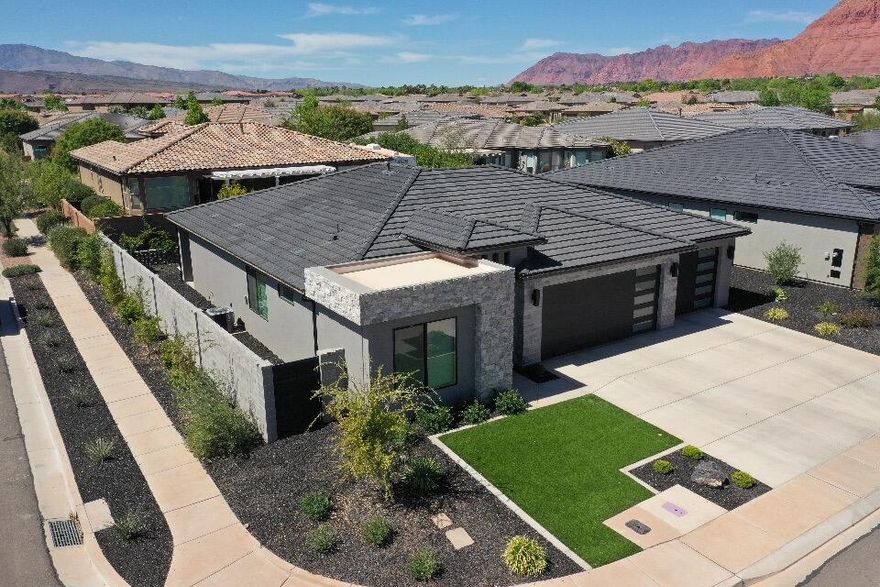 Set against the striking red rock backdrop of Ivins, this exceptional residence offers refined desert living just moments from the world-class amenities of Black Desert Resort. Designed to embrace its natural surroundings, the home blends indoor and outdoor spaces with effortless sophistication, capturing panoramic views and abundant natural light. Whether as a primary residence or luxury retreat, this is a rare opportunity to own in one of Southern Utah's most sought-after locations.