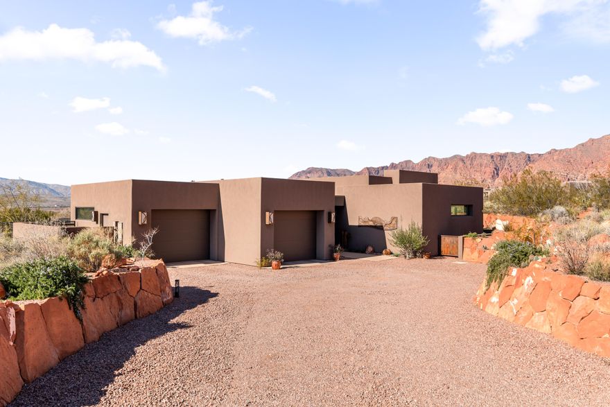 This stunning Kayenta contemporary home, built in 2018 and situated on a .40 acre lot on a quiet cul-de-sac directly beneath towering red cliffs, has 2,419 square feet, 3 bedrooms, 3 bathrooms and a generously-sized 3 car garage.  Highlights include  10 foot floor-to-ceiling glass windows, sleek polished concrete floors throughout, triple sliding glass patio doors, 2 separate outdoor covered patios, custom-designed kitchen with high end appliances (including French door-style wall oven and induction cooktop, oversized butler's pantry, and tons of storage.  The home has lots of natural lighting with windows facing virtually every direction and complemented by 5 skylights.   The primary bedroom has a walk-in closet with built in dressers and heated floors in the bathroom. The north patio provides provides a comfortable seating area with red mountain views and is landscaped with low to no maintenance required, whereas the south patio is covered and can be enjoyed in any weather as it is equipped with ceiling heaters, ceiling fans and recessed lighting, has a mounted TV and is plumbed for a BBQ.
The garage at 723 is just under 1,000 square feet in size, where you'll find the full sized washer and dryer with a utility sink.  A 50 AMP outlet  to power electric vehicles has been thoughtfully included during construction.  The home is also wired for solar.

Enjoy access to nearby hiking trails, protected night skies, awesome sunsets, privacy and tranquility all within a short drive to the renowned Kayenta Art Village, with its cultural (Center for the Arts in Kayenta), recreational (swimming, pickleball, tennis), retail (numerous art galleries, and culinary offerings (Xetava and Rusted Cactus).  723 is your desert sanctuary in the heart of a very special  community.  Come see for yourself.