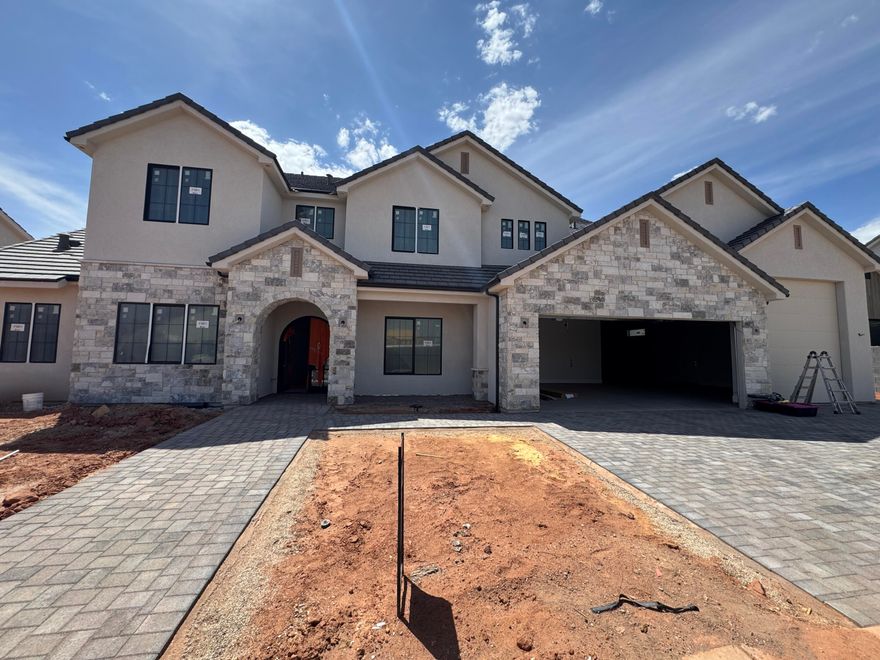 New Construction home in Crimson Cliffs boundaries with Salt-Water Pool with Slide, 40' deep RV garage with a climate controlled storage room & 20'+ tall ceilings in the living room. Backyard oasis with salt-water pool, waterslide, spa & motorized cover with a turf area & back patio as well. RV garage with over 40' of depth + a storage room & epoxy floor. Very functional floorplan with 10' ceilings on the main, large picture windows, living room with 20' + ceiling & upstairs a second living & laundry room each. Chef's kitchen with gigantic butler's pantry & quartz countertops & GE appliance package & oversized built-in fridge/freezer. Luxurious primary suite with beautiful arch above the free-standing tub, walk-in shower & large walk-in closet. Exquisite finishes throughout home from the stained luxury cabinets, designer tile to the stunning finish carpentry home is a MUST SEE! Schedule a showing to see the home for yourself today.