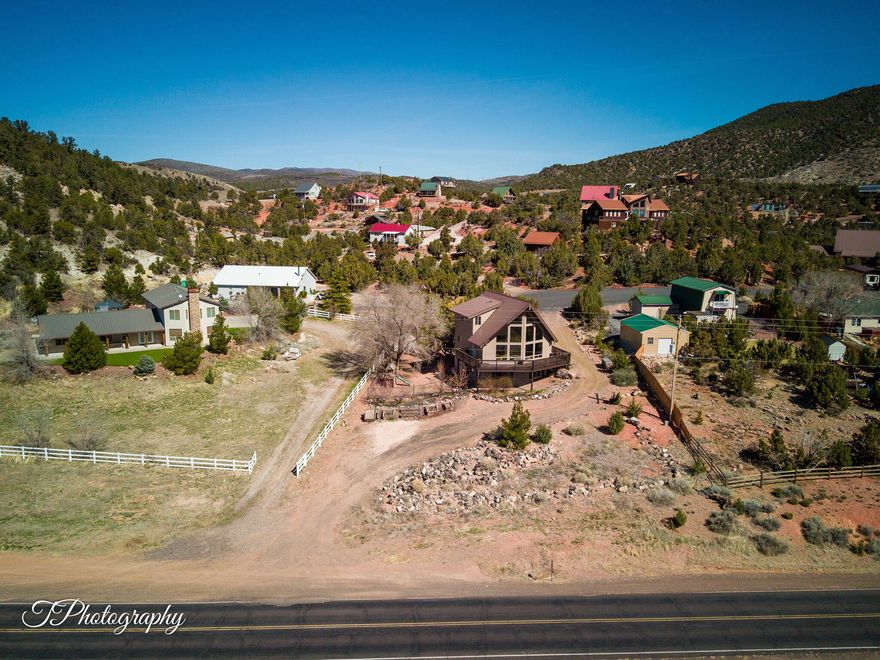 Amazing views!  Walkout basement with full kitchen, living area, bedroom, bath and laundry.  Main floor also has kitchen, living area, bedroom and bathroom.  Full master suite on second story, large great room, bunk room, or?  Drive off main road to basement or drive into main level off Foothill Cir with side drive connecting both.  Large lot and great neighbors.