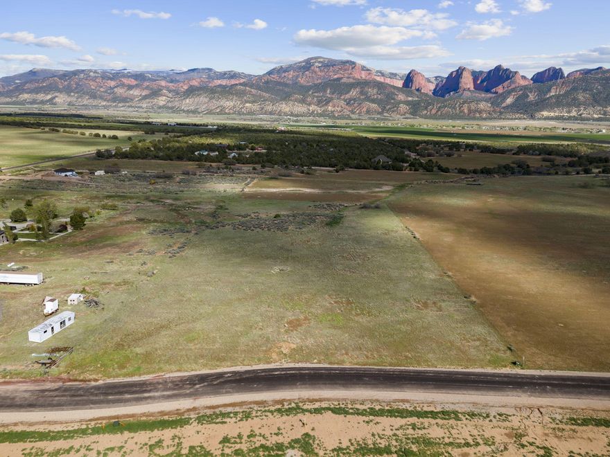 Tucked into one of Southern Utah's most stunning valleys, this rare 6-lot subdivision offers spacious parcels ranging from 5 to 6 acres each—perfectly positioned to take in breathtaking views of both Kolob Canyon and Pine Valley Mountain. Whether you're looking to build your dream home or invest in a piece of this peaceful paradise, these lots offer the perfect blend of space, beauty, and convenience.
Each lot is gently nestled into the landscape, offering a serene, private feel while still being part of a thoughtfully designed neighborhood. The setting is truly one-of-a-kind—surrounded by wide-open skies, incredible sunsets, and mountain backdrops in every direction.
Utilities are already in the street, making your build process easier and more affordable. Taxes to be determined