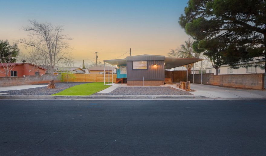 Stunningly cute home with a two-car garage, loads of off-street and RV parking, and no HOA. This unique property has been meticulously renovated from top to bottom, inside and out. Flooring, windows, siding, fixtures, appliances, insulation, HVAC, and landscaping have all been professionally updated to create a charming ''tiny-home'' vibe with abundant natural light throughout. There is also an additional small room that could work well as a 3rd bedroom or office. The fully xeriscaped yard and beautiful lawn offer minimal maintenance, with two fully fenced areas for kids and pets and a brand new shed with a cement foundation for extra storage. The nearly quarter-acre property features eight off-street parking spaces (three covered) for RVs, toys, and guests, plus a two-car garage. Located within walking distance to stores, Snow Canyon State Park, city parks, schools, pickleball courts, and more. A separate tiny home is located at the back of the property and is currently occupied; it is not included in the sale but may be negotiated separately. Please do not disturb the occupant.