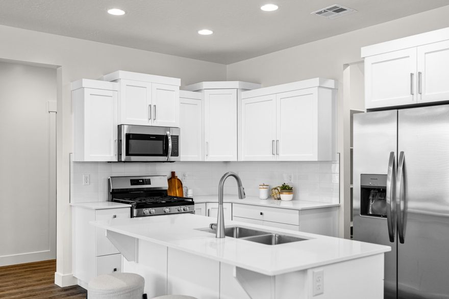 4 bed with Primary on the main level, 2.5 bath home with a 2-car garage in the brand-new Desert Reflection community by Salisbury Homes. Features include EVP flooring in main living areas and bathrooms, upgraded carpet in bedrooms, quartz countertops throughout, stainless steel gas appliances (fridge not included), modern cabinets, and kitchen backsplash. Community park, trails, and amenities nearby. NOTE: Interior and exterior finishes are predetermined and may change. Photos are examples of the finishes are also subject to change. TAKE ADVANTAGE OF A $10,000 LENDER INCENTIVE AND GET A LOWER RATE! Buyer/agent to verify all info.