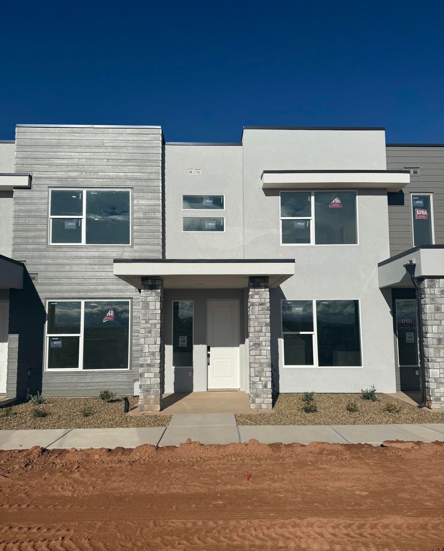 This inviting 3 bedroom, 2.5 bathroom townhome boasts a prime location just moments away from Zion Shores surf park, Warner Valley, and Sand Hollow making it perfect for outdoor enthusiasts and adventure seekers. The spacious living area flows seamlessly into a well-appointed kitchen complete with stainless steel appliances. The generous primary bedroom is complete with an en-suite and walk in closet. Two additional bedrooms provide plenty of space for guests, a home office, or hobbies and they share a stylishly designed full bathroom. A convenient half-bath is located on the main level. Step outside to enjoy your own covered patio where you can enjoy views of Warner Valley and Pine Valley.