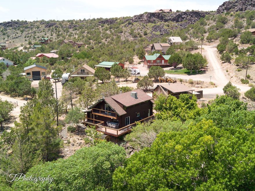 Enjoy year-round living in this updated Brookside cabin, tucked in the trees and backing to the Santa Clara River. Inside, you'll find a remodeled kitchen with new appliances and reverse osmosis, updated bathrooms, vinyl flooring throughout, PEX plumbing, fresh baseboards, live-edge wood shelving, and modern lighting. Take in the views from the refinished deck or the private balcony off the primary bedroom. Relax in the redwood barrel sauna in the evenings. Just steps from hiking and biking trails, this property is perfect for outdoor lovers. The detached 2-car garage includes an ADU (casita/apt) above, ideal for guests or as an income-producing rental. No HOA. Seller willing to contribute towards buyer closing costs with an accepted offer. Seller Financing Possible.
