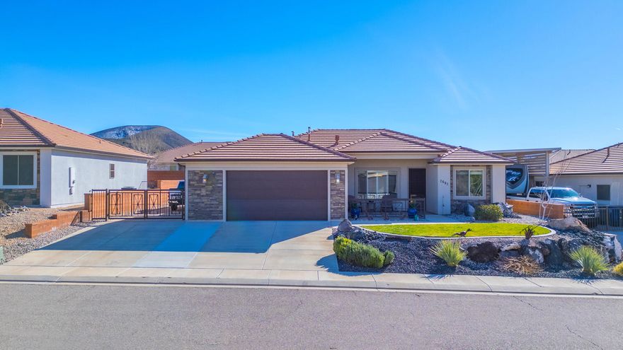 Located next to the beautiful Sky Mountain Golf Course, this exceptional home offers comfort, quality, and thoughtful upgrades throughout. From the moment you arrive, you'll notice the custom driveway gate, expanded garage with extra insulation, and fully landscaped front and back yards designed for both beauty and easy maintenance.
The large, fully fenced backyard is perfect for entertaining or relaxing in privacy, complete with an RV pad featuring full hook-ups -- a rare and valuable addition.
Inside, the home showcases granite countertops, tile flooring, and elegant plantation shutters in the living room. The kitchen is a standout with upgraded Bosch appliances including a refrigerator, gas stove, dishwasher, and microwave, along with a charming French door that adds both light and character.
The primary suite offers a beautifully upgraded bath with a glass-enclosed shower for a clean, modern finish. Additional premium features include a tankless water heater, water softener, elastomeric exterior paint for added durability, wrought iron patio railings, and a security screen door with interchangeable screen and glass inserts.
This property blends functionality, luxury, and location -- offering an exceptional opportunity in a highly desirable setting. Glass subway tile backsplash Upgraded granite in both bathrooms Added two extra rows of cinder block on back wall Paver area for fire pit in back yard Added cement to extend driveway and walkway from back patio to drive way Pull out shelves in lower cabinets with a pull-out spice tray in upper cabinet Luxury Vinyl Plank (LVP) throughout house Expoxy coating on front and back patios Interior painted less than one year