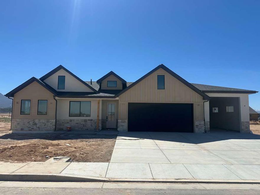 Beautiful new construction offering 1,863 sq ft of living space on an oversized 0.49-acre lot in Cedar City. This 4-bedroom, 2-bath home features an open and spacious layout with 12-foot ceilings in the entry, 9-foot ceilings in the bedrooms, and upgraded 8-foot interior doors throughout, creating an open and upscale feel.

The kitchen showcases light oak cabinetry to the ceiling, a built-in microwave, and a metal vented range hood for both style and functionality. The primary suite offers a spa-like retreat with a double-headed walk-in shower and a freestanding soaking tub.

Enjoy stunning mountain views and a large lot with ample space for RV parking, outdoor toys, or future improvements. The oversized garage provides plenty of room for a boat, small camper, or extra storage. Front landscaping will be completed, and the backyard includes a finished wall for added privacy. Lockbox is not Supra.