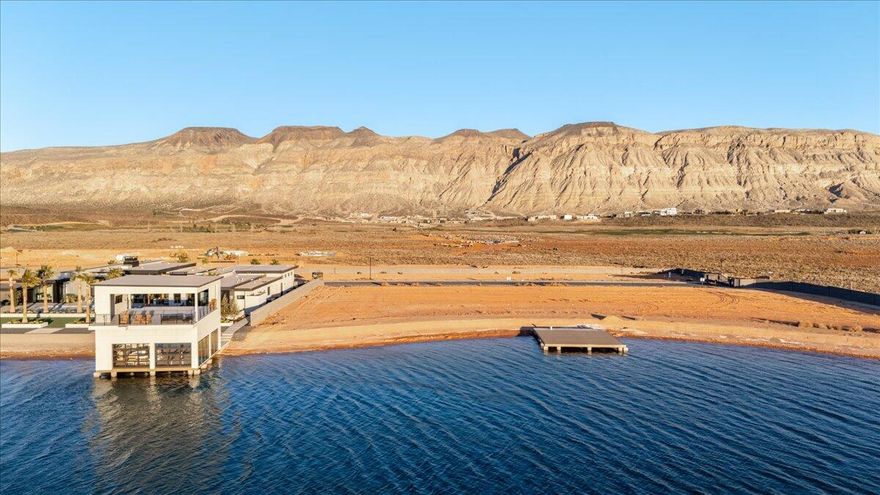 Rare opportunity to own one of the last remaining waterfront homesites in the exclusive Southern Shores wake lake community in Hurricane. Positioned along the crystal-clear shoreline with direct water access, this premium lot offers the perfect setting to build a custom lakefront retreat surrounded by Southern Utah's stunning red rock scenery and mountain views.

Start your mornings on calm glassy water, spend the day paddleboarding, surfing, boating, or wakeboarding just steps from your backyard, and end each evening with unforgettable desert sunsets reflecting across the lake. The private boat dock is already in place, with the option to build a fully customized boathouse tailored to your vision and lifestyle.

Southern Shores is a one-of-a-kind waterfront community featuring a rare three-lake system designed for every type of water enthusiast, including a dedicated boat lake, a cable lake with wakeboarding obstacles, and a surf lake engineered for endless waves. Residents also enjoy resort-style amenities including a clubhouse, pickleball courts, tennis courts, and sand volleyball.

Located just minutes from Sand Hollow Reservoir, championship golf, hiking, biking, and endless outdoor recreation, this homesite delivers the perfect balance of adventure, luxury, and privacy. Bring your own builder and design a modern masterpiece with seamless indoor-outdoor living, expansive entertaining spaces, and panoramic waterfront views.

Waterfront opportunities like this are exceptionally rare in Southern Utah. Build the lakefront lifestyle most people only dream about.