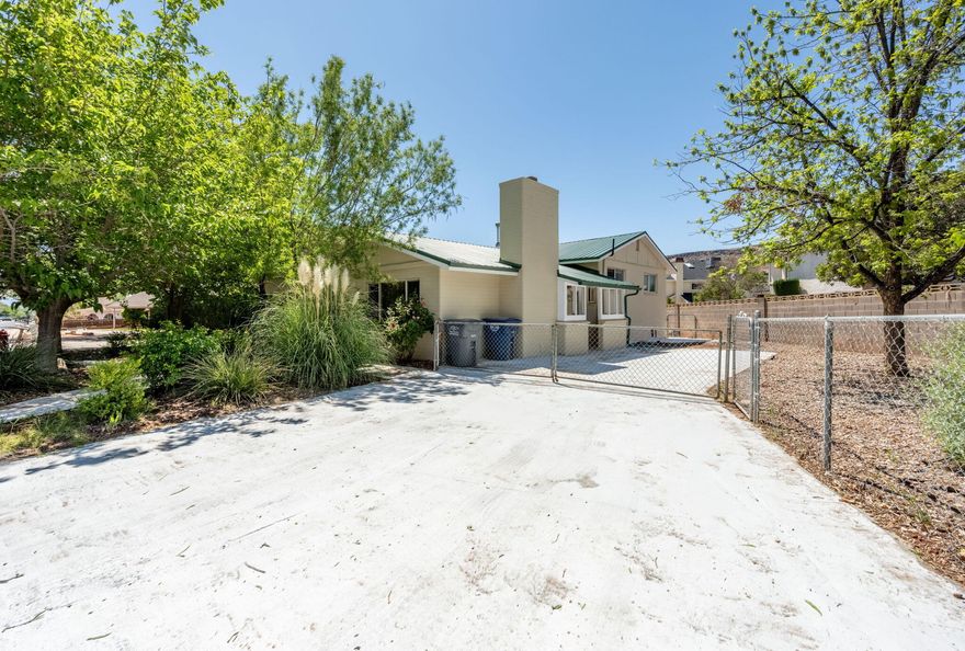 Welcome to this beautifully maintained 5-bedroom, 3.5-bath home in the heart of St. George. This property features an open, inviting layout with hardwood and tile flooring throughout, along with convenient RV parking. It also includes a fully equipped 2-bedroom, 1-bath basement apartment with a private entrance and separate heating and cooling, offering excellent flexibility for rental income.