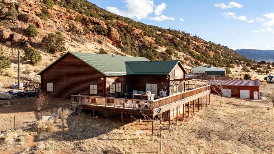 $20,000 SELLER CREDIT. 1 ACFT water share, 500 gallon water tank and water softener. Recently purchased 54 panels, full Tesla walled solar system, 89K. Lovely home on the outskirts of Paragonah with gorgeous views in all directions! This full log home features 3 bedrooms and 2 bathrooms. Large open floor plan with large windows. Master bedroom has full views of valley, large walk-in closet and pellet stove. There are vaulted ceilings throughout the house. Spacious kitchen with outside entrance and an island. Outside features a large back deck, a 30' X 45' metal building w/ concrete floor, perfect for a workshop and an attached garage. Perfect location for those who snowboard, ride ATV's, hike and enjoy outdoor activities. Brian Head, Panguitch, Bryce Canyon, Zion and Cedar Breaks are basically in this home's backyard.