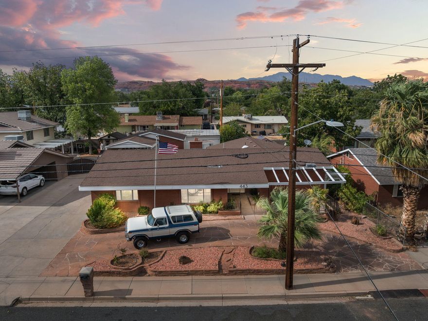 Retro Rambler | Built in 1972 and still bringing the charm, this classic brick beauty sits right in the heart of St. George. Inside you'll find 4 bedrooms plus a bonus 5th room or potential casita with its own entrance, perfect for guests, a home office, or that moody teenager. The inside got a full glow-up! New kitchen top to bottom! All new appliances, engineered hardwood flooring, carpet, tile & fixtures, but we kept the character. Think of it as a facelift with soul.
The large & charming backyard has raised garden beds, a greenhouse, and plenty of room to roam. 
Just 2 miles from Utah Tech and walking distance to schools, parks, and shopping. No HOA, but a whole lotta charm and all the modern updates where it counts.