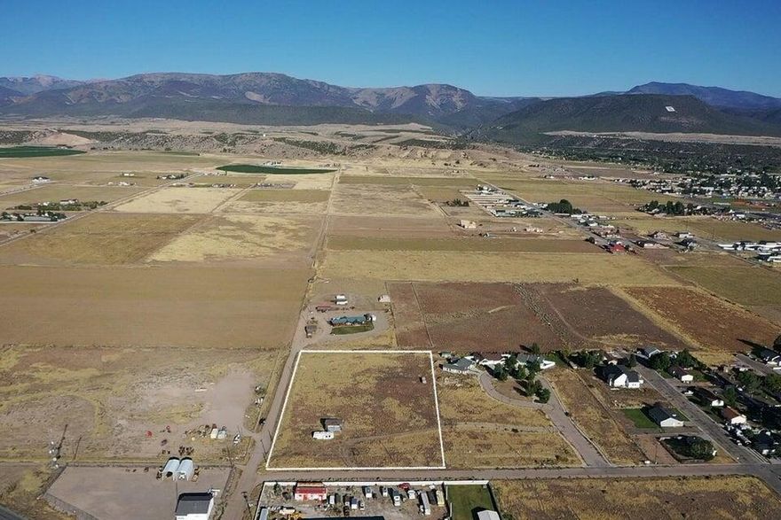 3.5 Acre Commercial Lot with Mountain Views - Prime Location Near Main Street Don't miss this rare opportunity to own 3.5 acres of commercial land in a highly desirable location just off Main Street. With sweeping mountain views and utilities nearby, this property is ready for your vision. • Utilities: Power is stubbed in. City water and sewer lines run in the road. Buyer will need to provide a 1955 or older water right to connect to city water. • Accessibility: Excellent access with close proximity to Main Street, making it ideal for a variety of business uses. • Restrictions: A deed restriction allows for only a single-story structure to be built on the east half of the lot or a multiple story on the west half.