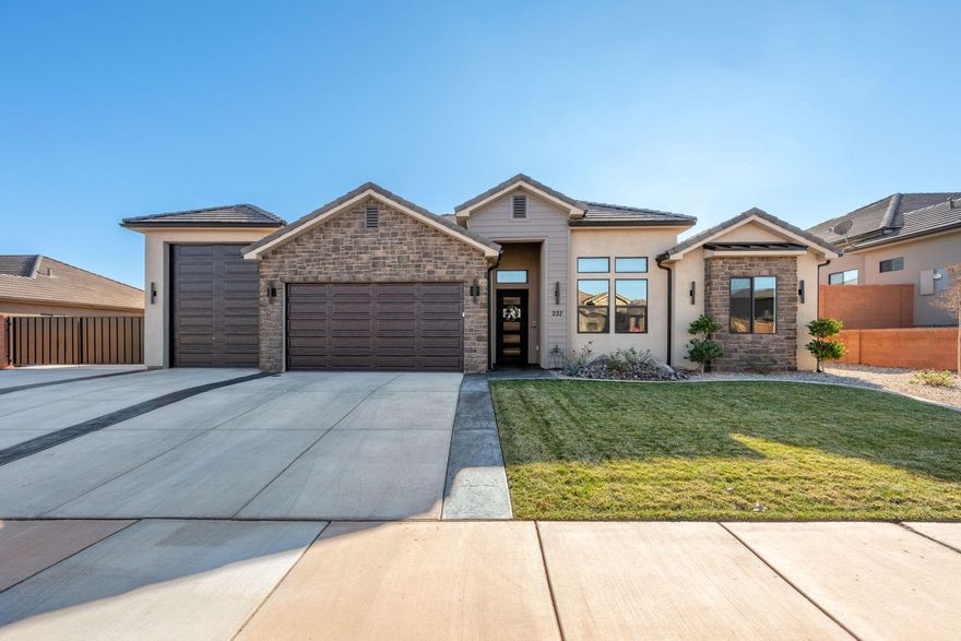 This beautiful, traditional-style home is located in the heart of Ivins, directly across from Unity Park. It features thoughtful upgrades throughout, including a tasteful blend of white painted cabinetry and warm knotty alder cabinets, complemented by elegant Vanilla Quartz countertops. The home includes a large pantry along with a butler's pantry complete with a sink, offering added functionality and storage.

Additional features include an RV pad on the east side of the home, an iron RV gate, a 36-foot RV garage, a custom iron front door, and GE Café appliances. The backyard offers impressive views and ample space suitable for a future pool, subject to local approvals and requirements.

The property is conveniently located near hiking and biking trails, Snow Canyon State Park, Tuacahn Amphitheatre, Kayenta Art Village, and Gunlock Reservoir.