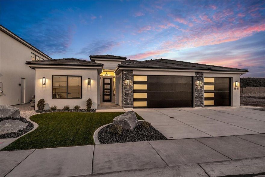 Step into this stunning 1,900 sq. ft. home in our newest community, Desert Talus! Featuring a brand-new Stratford elevation and a thoughtfully designed open-concept layout, this home has it all. The beautiful kitchen showcases quartz countertops, upgraded painted cabinets, and a stylish tile backsplash that perfectly ties the space together. Timeless finishes create a look that feels elevated yet inviting, while durable LVP flooring runs through the entry, living, and kitchen areas for everyday ease. All bathrooms include elegant tile flooring for a polished finish. Outside, full landscaping completes the home, with low-maintenance synthetic grass in the front yard to keep it looking great year-round. Come see this beautiful home today!