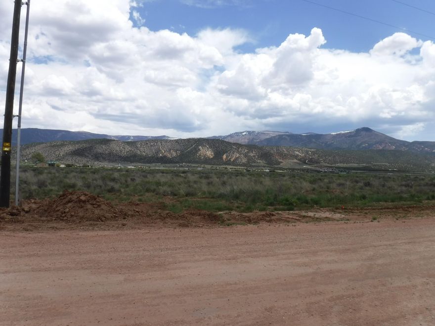 19.57 acres SE   corner 3600S 6100W 
west of Exit 51 I-15  Power telephone, US West Internet Cable, graded roadways, new custom home going in directly west Views to beat all!!
Buyer will need to purchase 1 acre ft of water right as existing permit went to State due to non use 5520 ft elevation and cool   water right needs to be purchased in Basin area 73 and approved by Utah State Water Resource Division