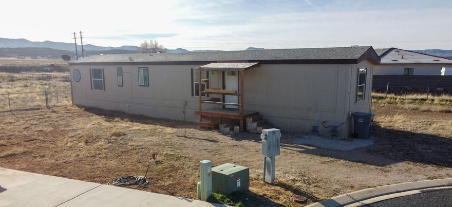 Own this well-maintained 1997 single-wide manufactured home situated on its own fully fenced 0.35-acre lot. The 952 sq ft home offers 2 bedrooms and 2 bathrooms and features durable 2x6 construction. Enjoy year-round comfort with heating and air conditioning.

The home comes fully equipped with a range, dishwasher, refrigerator, washer, and dryer. New roof shingles installed in 2018. Move-in ready and versatile—ideal as a primary residence, second home, or investment property.

Seller is related to listing agent.