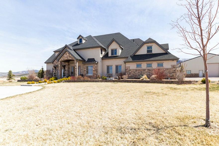 Discover your dream property in this beautifully designed, custom-built home offering approximately 6,300 sq ft of living space, 3000 sq ft shop rough plumbing for apartment, situated on 20 acres with breathtaking views into Shirts Canyon. Built in 2016, this spacious residence combines luxury, function, and flexibility—perfect for a wide variety of lifestyles. Step inside to find a thoughtfully laid-out floor plan featuring seven bedrooms and four and a half bathrooms. The main level boasts three bedrooms, including a generous owner's suite, plus a home gym, a dedicated office, and a formal dining room ideal for entertaining. The gourmet kitchen is equipped with a walk-in pantry, a hidden spice rack, and abundant space for culinary creativity.