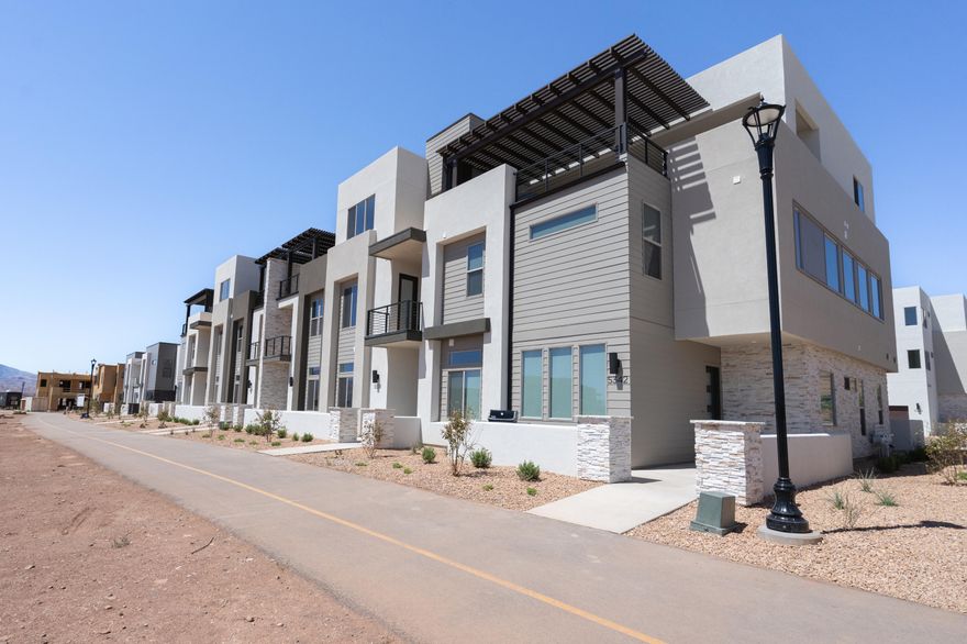 Discover the Pacific II, a standout in the acclaimed Desert Color community, offering 3,605 square feet of living space. With 5 bedrooms, 5.5 bathrooms, and a 1-car garage, this townhome boasts a gourmet kitchen, built-in banquette, and mini bar for the ultimate vacation. Bunk rooms ensure plenty of space for larger groups, while the second-floor deck, complete with a hot tub and fire table, provides the perfect spot to unwind after a day of adventure in Southern Utah.