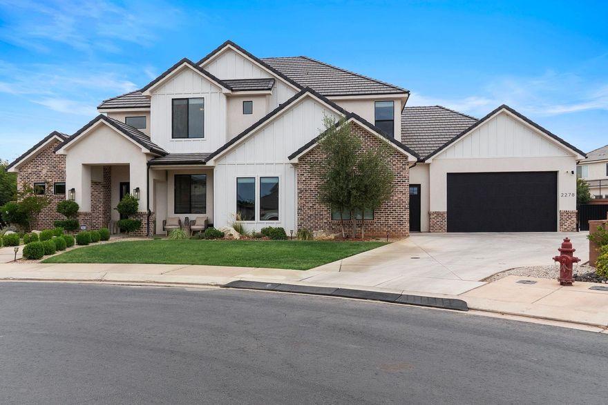 Tucked away at the end of a quiet cul-de-sac in highly sought-after Little Valley, this exceptional custom-built estate offers the perfect blend of luxury design, functionality, and resort-style living -- including the rare opportunity for qualified veterans to take advantage of an assumable VA loan (3.25%). Built in 2021 and thoughtfully designed for both entertaining and everyday living, this stunning 5-bedroom, 4-bathroom home spans approximately 3,500 square feet and sits on a beautifully landscaped 0.37-acre lot complete with a saltwater pool, hot tub, expansive patio spaces, and incredible garage/RV capabilities rarely found in Southern Utah.
From the moment you enter, you're welcomed by soaring ceilings, dramatic floor-to-ceiling windows, abundant natural light, and a striking stone fireplace anchoring the spacious great room. The open-concept design flows seamlessly into the gourmet kitchen featuring high-end finishes, oversized island seating, custom cabinetry, and an impressive butler's pantry offering exceptional storage and prep space.

The thoughtfully designed floor plan includes multiple living and entertaining spaces, including an upstairs bonus/family room along with two upstairs bedrooms -- one featuring a private ensuite bath and walk-in shower -- creating the perfect setup for guests or multigenerational living.

The luxurious primary suite offers a spa-inspired bathroom with expansive dual vanities, custom finishes, and generous storage. Additional bathrooms are thoughtfully appointed with multiple walk-in showers and an upstairs tub/shower combination.

Car enthusiasts and outdoor adventurers will appreciate the massive 1,604 sq. ft. heated and cooled garage setup accommodating 6-7 vehicles, complete with epoxy floors, mini-split heating and cooling, and rear garage door access to the backyard. Coupled with oversized RV/toy storage capabilities and an additional side parking pad ideal for boats, trailers, RVs, and recreational vehicles, there is truly room for all your toys.

The backyard is designed for true indoor-outdoor living with an oversized covered patio plumbed for natural gas, resort-style saltwater pool and spa, expansive concrete entertaining areas, and beautifully maintained landscaping creating a private retreat perfect for relaxing or entertaining year-round.

Additional premium features include:

* Assumable VA loan available for qualified veterans
* Reverse osmosis water system
* Water softener
* Central vacuum system
* Tankless water heater
* Epoxy garage floors
* Heated/cooled garage with mini split
* Oversized RV/toy parking
* Rear garage access to backyard
* Modern farmhouse finishes throughout

Located in one of St. George's most desirable neighborhoods near top-rated schools, parks, trails, and amenities, this remarkable property delivers luxury Southern Utah living at its finest.