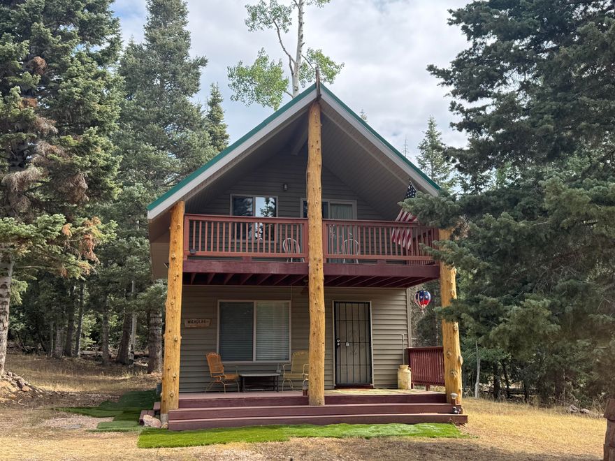 Mountain Retreat tucked in the forest with Cabin, Loft & Workshop on 1-acre lot! Escape to the serene beauty of Navajo Lake Estates with this 2-Bed, 2 Bath cabin featuring a spacious loft for additional sleeping space. The cabin is nestled on one lot with a workshop on the other. Cabin was built in 2009-solid construction and thoughtful design. Windmill, generator and solar powered with 8 batteries, eliminating the need for electricity or the power bill. Water trailer and 1200-gallon water tank and access to a local spring, the cabin is well insulated, has pex piping, and double pained windows. Covered decks to enjoy the mtn air, RV parking. Propane fridge and stove. A travel trailer has been converted into a storage shed. Enjoy family and friends around the firepit. MUST SEE TO BELIEVE!
