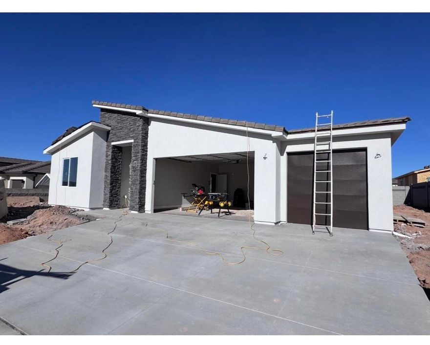 New home in beautiful Sky Mountain golf course development, offering refined living with the freedom to personalize! Finishing construction, this 3-bedroom, 2-bathroom 3 Car Garage home perfectly blends comfort and functionality. Enjoy beautiful sunsets. Home equipped with quartz countertops, soft-close doors and drawers, a stunning tile primary shower, durable LVP flooring, and stylish two-tone paint. Added privacy and security with rear and side wall already included. Don't miss the chance to own a brand-new home in a community where you have the freedom to make it yours! Photos are of a similar home. Contact one of our agents today to find out how you may customize this home to your style. Hurry in today! An amenities association is available; ask one of our agents about the details.