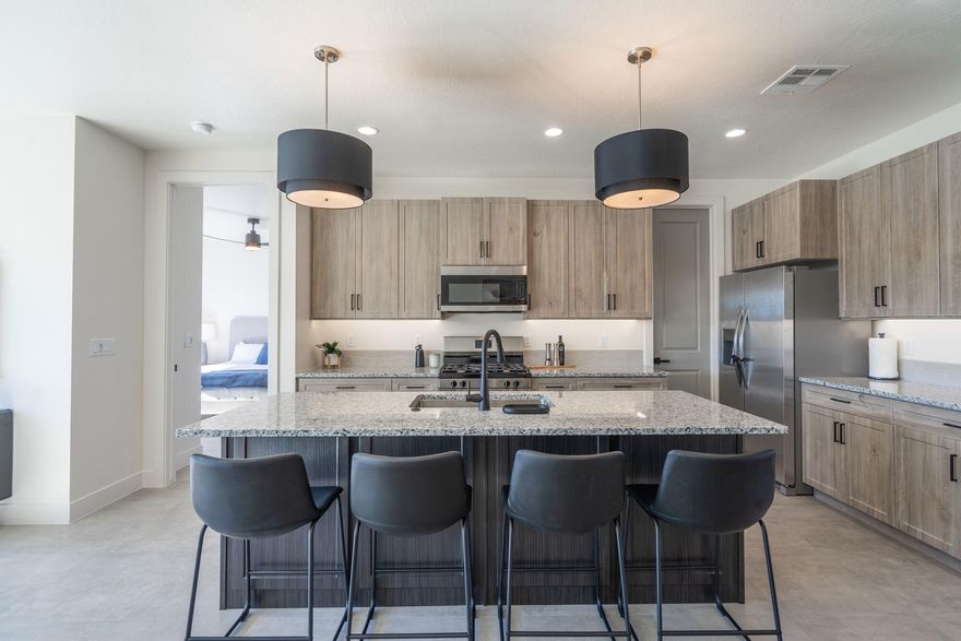 The Luna - This well-designed 3-bedroom, 2.5-bath home offers modern living with an open-concept layout connecting the spacious great room and stylish kitchen. Features include thermofoil cabinetry, granite countertops, a single-bowl stainless steel undermount sink, and a Frigidaire stainless steel appliance package with electric range, microwave hood, dishwasher, and refrigerator. Interior finishes include two-tone paint, tile or laminate flooring in main living areas, carpet in bedrooms, can lighting throughout, and ceiling fans in the living room and bedrooms. Bathrooms feature Moen plumbing fixtures and custom tiled showers/tub surrounds. Additional highlights include a laundry room with sink cabinet, extended finished garage with 50-amp EV breaker and room for a workshop or toys, block walls, and backyard space. Community amenities include a pool, hot tub, pool house, pickleball court, playground, and RV parking.

Pool House, Playground and BBQ area coming NOW!

Photos of similar home. Same floor plan; finishes, colors, and layout orientation may vary.