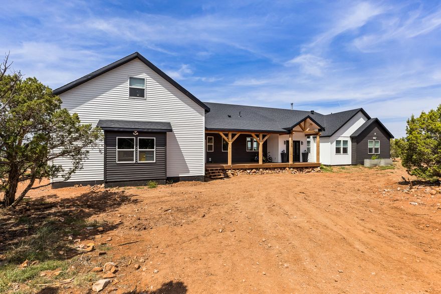 Off-grid luxury estate on 20 fully fenced acres at the base of the Cove Mountains between Enterprise and Newcastle. Built in 2024, this 3,933 sq ft home offers 4 bedrooms, 3 baths, office, exercise room, 338 sq ft bonus room, and 673 sq ft 2-car garage. 12' ceilings in the great room, 12' quartz island, double dishwashers, butler pantry with commercial refrigerator, pot filler, custom cabinetry, surround sound, expansive decks, and multi-camera flood light security system for added safety. The master suite features a sitting area, soaking tub, 46 sq ft dual rain shower, and private laundry, plus a second main laundry in the mudroom. Hydronic heat, 3 wood stoves, Senville minisplits, 4-stage filtration. Fully off-grid with well (1 AF of Water Right), septic, 48V solar, 50kW batteries, Generac, propane, fiber optic. 792 sq ft detached casita (ADU) with kitchen (80% finished), W/D, fireplaces--ideal for rental or multi-gen living. Wildlife, junipers, AG20 Greenbelt. A must see.