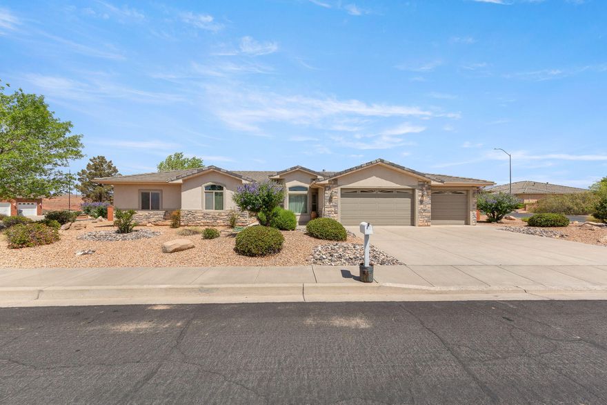 Beautiful single-story home in a quiet and established St. George neighborhood. Enjoy a comfortable living space with an open-concept layout, large picture windows, and abundant natural light throughout. The inviting living room features a cozy fireplace and flows seamlessly into the kitchen and dining area, creating the perfect space for entertaining or everyday living. The oversized primary suite includes a spacious ensuite bath with dual vanities, soaking tub, separate shower, and generous walk-in closet. Quality finishes throughout include granite countertops, custom wood cabinetry, tile flooring, and vaulted ceilings. Enjoy the low-maintenance desert landscaping, fully fenced backyard, and covered patio areas ideal for relaxing outdoors. The oversized 3-car garage provides ample space for vehicles, storage room which is climate controlled with exterior door for hobbies or a workshop potential. Conveniently located near shopping, dining, parks, golf, and all that St. George has to offer. Well maintained and move-in ready. This home combines comfort, space, and functionality in a highly desirable location.
