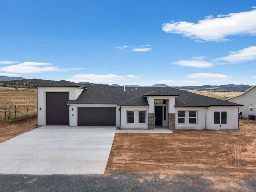 Enjoy the safety and comfort of small town living in Enterprise! This new construction home is built by an experienced local builder on a nice sized lot. It offers beautiful fixtures, tile flooring, quartz countertops, large bedrooms and a spacious RV garage! This gem is priced to sell! Located in a new area close to the beautiful community park, complete with a pond and walking path, with a great view and a peaceful mountain feel. Just a quick commute from St. George or Cedar City waits your next adventure! 
40 ft RV Garage. Door: 10' X 14'
All information deemed reliable, but not guaranteed. Buyer to verify all information.