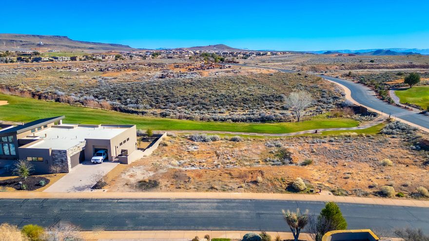 Large walk-out view lot ideally positioned on Hole #17 in the prestigious, gated Ledges Westside community. Enjoy sweeping fairway and mountain views to the east, paired with breathtaking vistas of Snow Canyon State Park to the west. This premier homesite offers a rare blend of privacy, scenery, and luxury living—perfect for building your dream home just 10 minutes from St. George, with access to the Ledges Golf Club, clubhouse, and restaurant.