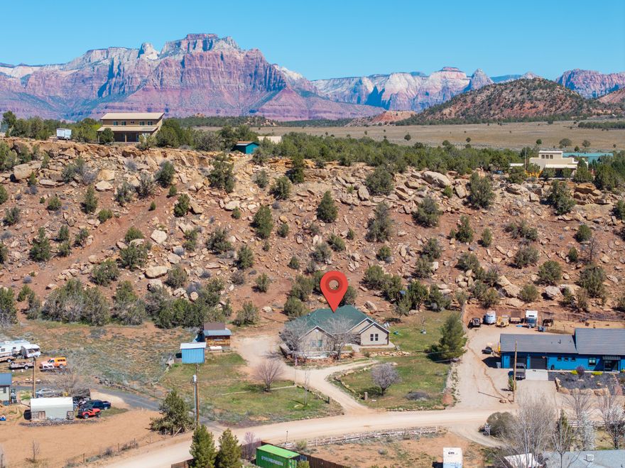 **Orchard, Views, and Space to Settle In**

Set on just over an acre in Apple Valley, this 4-bedroom, 2-bath home offers space, privacy, and a setting that's hard not to fall in love with. Surrounded by views of Zion, Canaan Mountain, Little Creek Mesa, and the open desert landscape, there's a quiet beauty here that feels a bit removed from everything. The home has been nicely updated with new flooring, paint, fixtures, and appliances, along with custom touches that add warmth and character. Outside, the property offers so much to enjoy and grow into. There's an established orchard, raised garden beds, and a chicken coop already in place, plus additional outbuildings for storage or projects. Whether you've been dreaming of a small hobby farm, space for animals, or just room to spread out, there's flexibility here to make it your own. The yard feels tucked away and private, with space for gathering, playing, or merely enjoying the quiet. There's also plenty of room for parking, toys, and all the extras that come with this kind of lifestyle. It's the kind of place where mornings feel a little slower, evenings last a little longer, and home feels exactly as it should.