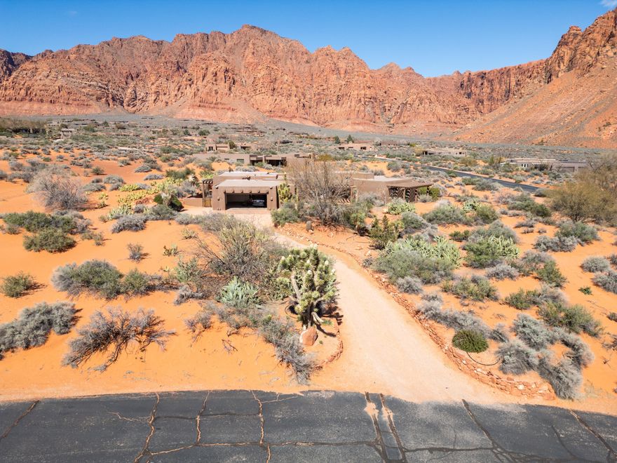 Breathtaking red rock views surround this spectacular desert retreat! The home features exposed wood beams, a beautiful custom wood ceiling, and colors and textures that complement the setting. A standout feature is the grand primary suite which boasts a separate sitting room with fireplace. The kitchen has newer cabinets and countertops. The expansive 1.62 acre lot provides exceptional privacy. Outdoor patio areas provide the perfect place to take in the incredible scenery and peaceful surroundings that make Kayenta one of Southern Utah's most unique and desirable communities. The tranquility, privacy, and breathtaking natural beauty of this home truly make it one-of-a-kind.