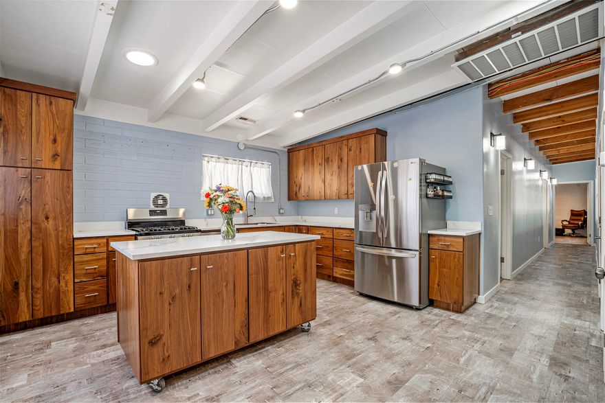 ADU OVERLAY WITH 3-CAR GARAGE! Location, zoning, and massive upside meet in downtown St. George. Situated in the highly coveted Utah Tech University footprint, this rare 0.20-acre property is fully entitled with both rental & ADU zoning overlays--offering an unmatched investment opportunity for student housing, or a primary residence. 
This stunning 1,312 sq. ft. single-story rambler has been remodeled, combining chic mid-century design with total peace of mind. Buyers will love the structural confidence of a fully updated home boasting a brand-new plumbing system and a completely upgraded electrical system, layered underneath architectural exposed beam ceilings, contemporary LVP flooring, and clean painted-brick accent walls.
The heart of the home is a premium chef's kitchen, beautifully redesigned with sparkling quartz countertops, full-height custom solid walnut cabinetry, stainless steel appliances with a gas cooktop, and a matching caster-wheeled central island for ultimate layout versatility and tons of storage. Both bathrooms are beautifully remodeled & modernized. The expansive bedrooms feature upgraded brushed-metal LED ceiling fans and windows for excellent natural daylight.
Beyond the main living space, the real exterior showstopper is that rare, 3-car detached garage alongside a massive attached utility carport-offering unparalleled secure storage for toys or a custom workshop. Fully enclosed with perimeter fencing, the yard offers a perfect blank canvas for low-maintenance desert landscaping. Nestled in a prime, historic downtown corridor, you are minutes from local dining, shopping, Call to Schedule a Tour,