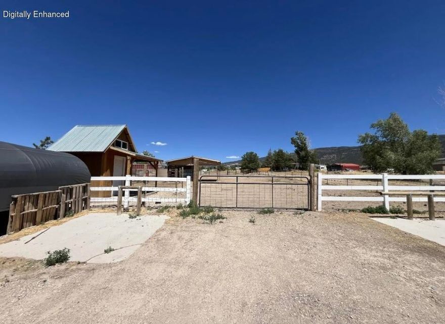 This property includes a Cherokee Timberwolf trailer and features convenient access from two separate roads, including one paved entrance and one gravel access point. Improvements on the lot include a covered structure tack shed, with water available on the property and additional utilities located nearby. Buyer to verify utility connection availability and associated fees.
