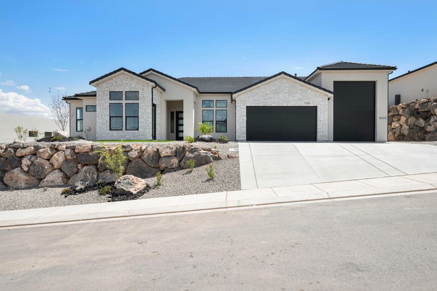 Boasting 10' ceilings and a welcoming fireplace with floating shelves, the interior is both inviting and spacious. The kitchen features a striking contrast of warm, bright cabinetry paired with dark fixtures and finishes, creating a perfect balance of elegance and modern style. The primary bedroom is generously sized and highlighted by a stunning A-frame vaulted ceiling, transitioning seamlessly into the regal primary bathroom, complete with a freestanding tub and a large walk-in closet. Beautiful guest spaces are designed with quality fixtures and finishes, ensuring comfort and style. Upon entering from the garage, you'll be greeted by a thoughtfully designed drop zone—perfect for backpacks, bags, groceries, and more. And speaking of the garage, it includes an RV garage that offers plenty of room for your toys and gear. Recently completed backyard landscaping enhances the home's appeal, featuring lush astro turf, a cozy gas fire pit, and a lowered block wall that opens up to breathtaking views of the surrounding mountains.