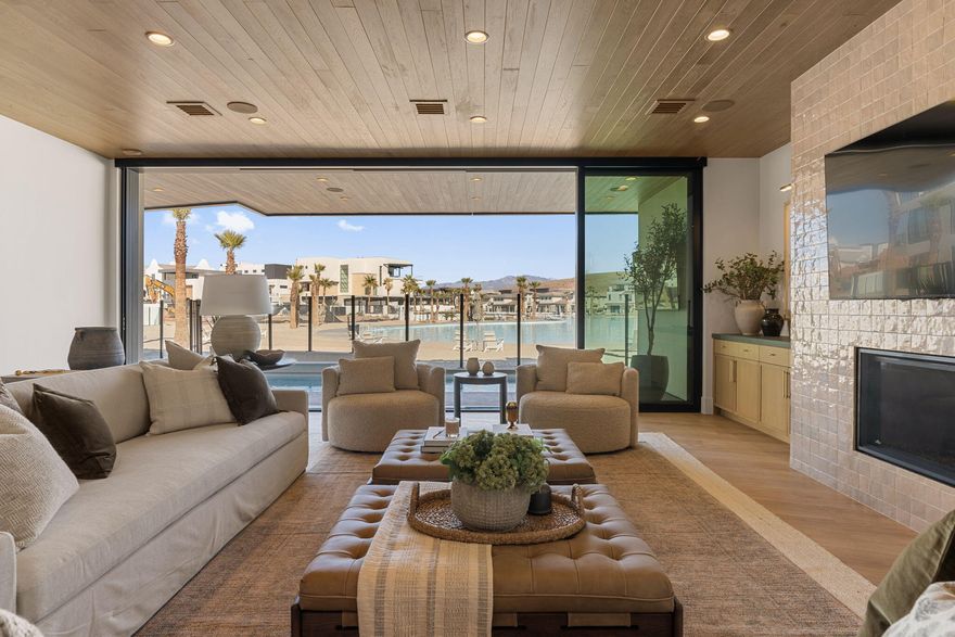 This extraordinary lagoon-front estate is one of the last opportunities to own directly on the water in Desert Color. Designed with both livability and legacy in mind, this 8-bedroom, 13-bathroom residence redefines what it means to gather well.

Unlike traditional large homes where guests are isolated by floor, the thoughtful layout was intentionally crafted so every level offers space for connection allowing kids, adults, and guests to be together without sacrificing privacy or comfort. The result is a home that truly works for how people live, entertain, and unwind.

Built by Split Rock Custom Homes and featuring high-end interiors by renowned designer Becki Owens, every detail feels elevated yet inviting, turning a showpiece into a home. Zoned for nightly rentals and accommodating up to 28 guests, the property offers an unmatched resort-style experience: a private pool and hot tub, expansive game room, theatre, gym, and a dedicated wellness suite complete with cold plunge, sauna, and steam shower. Multiple indoor and outdoor gathering spaces invite memorable moments, from quiet mornings to lively evenings under the stars.

Ownership also includes access to Desert Color's premier amenities, including the iconic 2.5-acre lagoon, additional pools and hot tubs, pickleball courts, and more creating a lifestyle that blends luxury, recreation, and effortless connection.

This is more than a home. It's a destination, a retreat, and a rare lagoon-front opportunity designed to bring people together.