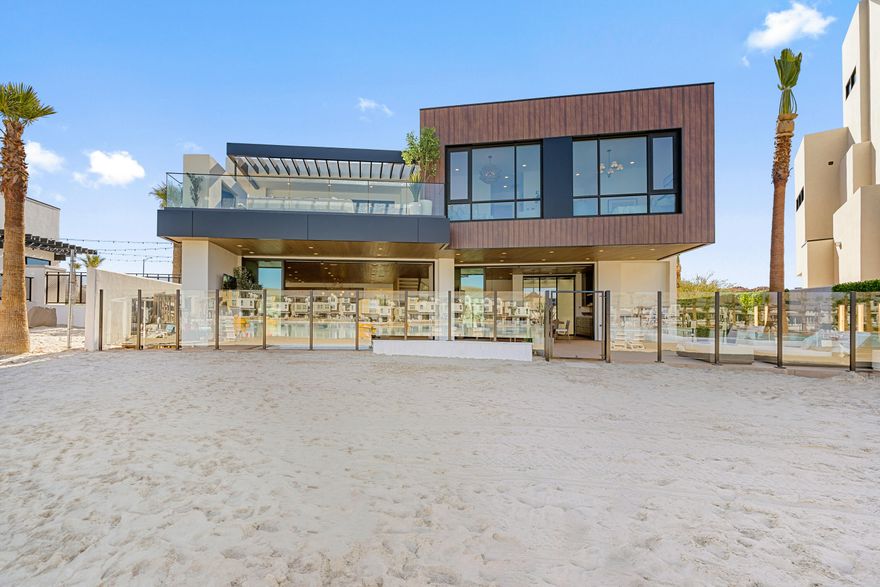 This extraordinary lagoon-front estate is one of the last opportunities to own directly on the water in Desert Color. Designed with both livability and legacy in mind, this 8-bedroom, 13-bathroom residence redefines what it means to gather well.

Unlike traditional large homes where guests are isolated by floor, the thoughtful layout was intentionally crafted so every level offers space for connection allowing kids, adults, and guests to be together without sacrificing privacy or comfort. The result is a home that truly works for how people live, entertain, and unwind.

Built by Split Rock Custom Homes and featuring high-end interiors by renowned designer Becki Owens, every detail feels elevated yet inviting, turning a showpiece into a home. Zoned for nightly rentals and accommodating up to 28 guests, the property offers an unmatched resort-style experience: a private pool and hot tub, expansive game room, theatre, gym, and a dedicated wellness suite complete with cold plunge, sauna, and steam shower. Multiple indoor and outdoor gathering spaces invite memorable moments, from quiet mornings to lively evenings under the stars.

Ownership also includes access to Desert Color's premier amenities, including the iconic 2.5-acre lagoon, additional pools and hot tubs, pickleball courts, and more creating a lifestyle that blends luxury, recreation, and effortless connection.

This is more than a home. It's a destination, a retreat, and a rare lagoon-front opportunity designed to bring people together.