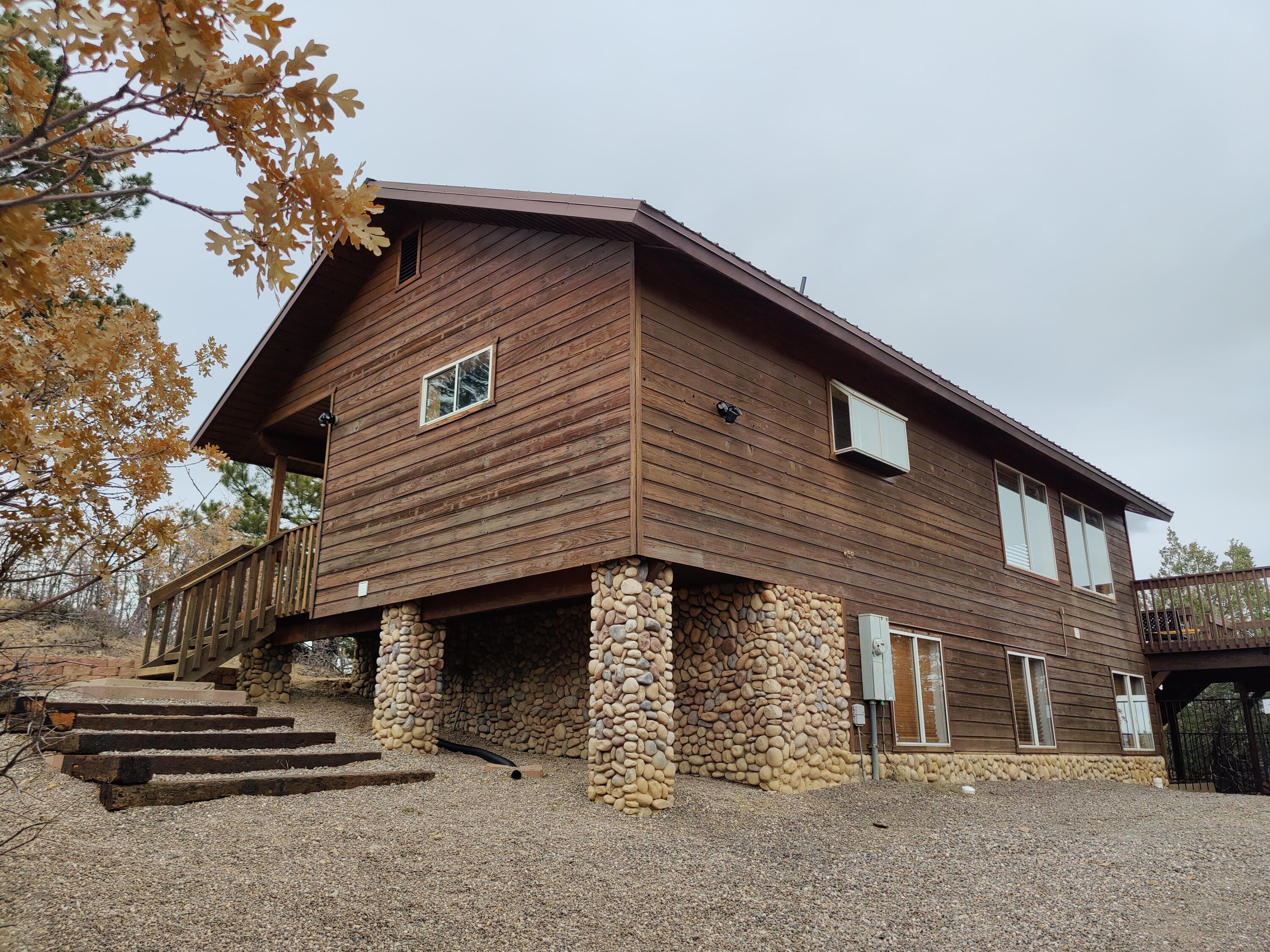 Discover this lovely cabin set on a peaceful half-acre conveniently located near Zion, Escalante and Bryce Canyon National Parks. Relax by the electric fireplace and stay warm with central, propane, and electric wifi heaters in every room, and in the summer enjoy the convenience of a portable A/C unit. Furniture and appliances can be negotiated to make your move easier. The HOA takes care of water and snow removal, ensuring a hassle-free lifestyle.