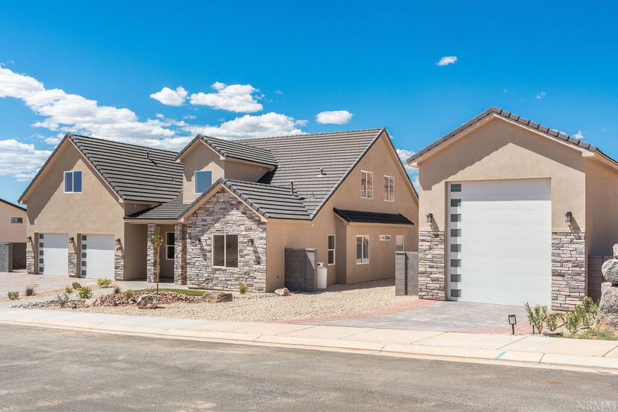 Luxury custom home on 0.40 acres with panoramic red rock views, Pine Valley Mountain, and North Zion National Park. 3,656 sq ft of well-designed living space includes 5 bedrooms, 4 baths, 2 full kitchens, and a butler pantry. A detached RV garage, sport court (pickleball-ready), and seamless indoor/outdoor living enhance entertaining, complemented by an outdoor kitchen.

The main home features an open floor plan with a gas fireplace, and ceiling fans throughout. The gourmet kitchen offers soft-close cabinetry and a butler pantry with a grocery pass-through from the garage. A practical mudroom provides built-in coat hooks and a dedicated Roomba station for easy organization. The luxurious master suite includes a walk-in closet, a two-person walk-in shower, a soaking tub, and a spa-inspired bathroom design.

A vaulted flex room with an exterior entrance provides versatility as a home business space, office, guest suite, or additional bedroom.

Upstairs, the attached casita sits above with exterior staircase access for private use while remaining connected to the home. It includes a full kitchen, bedroom, bathroom, living area, laundry, parking, and a private yard.

Outdoor living is designed for entertaining, featuring a sport court for pickleball and other activities, plus an outdoor kitchen to enjoy meals with views.

This home blends quality craftsmanship with comfort and livability, delivering a flexible, luxurious lifestyle without HOA constraints.