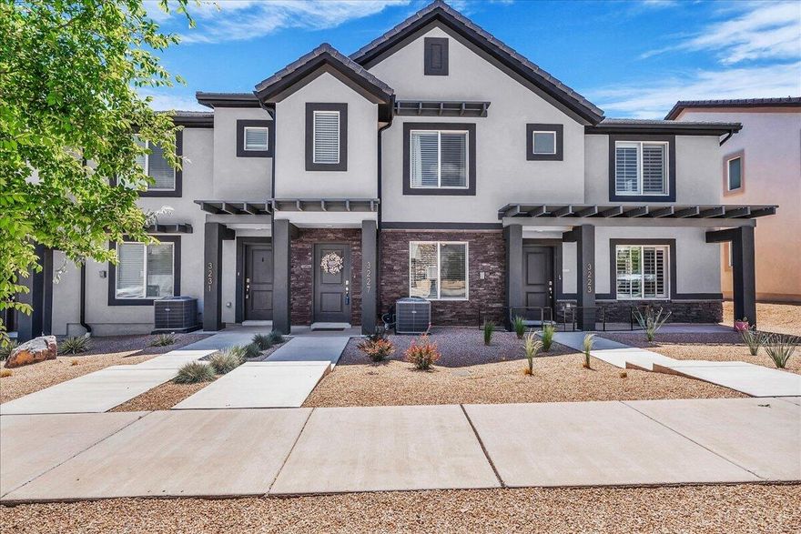 Enjoy low-maintenance living in this 3-bedroom, 2-bath townhome offering 1,315 sq ft and a 2-car garage. The interior features bright white cabinetry, stainless steel appliances, and an open, functional layout designed for everyday comfort. Located in the highly desirable Long Valley community, residents enjoy access to resort-style amenities including 2 pools, large hot tub, splash pad, pickleball courts, mini golf course, clubhouse, parks, playground, driving nets, dog park, and walking trails. Located 9 minutes from Sand Hollow - close to hiking, biking, boating, and more. Inclusions: Water softener, blinds, fans in all bedrooms, refrigerator, and the two mounted TVs.