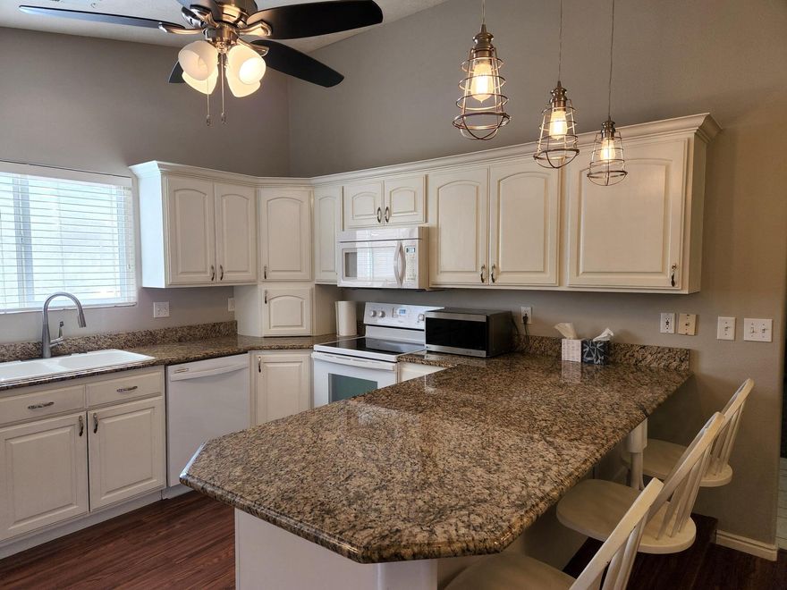 Come see this spacious 3 Bed with Den or Gym Room, 2 bath home in a desirable 55+ community! Featuring a large, bright kitchen with plenty of natural light, this home also offers a versatile bonus room with its own outdoor entrance—perfect for a gym, craft room, or guest space. Enjoy the private covered patio, RV parking with hookups, and low-maintenance artificial turf. Added upgrades include NEW AC unit with warranty, epoxy garage flooring with built-in shelving, and storm doors. Fridge, washer, and dryer are included! With a low HOA and convenient location just minutes from local stores, hospital, and the interstate, this home combines comfort, function, and value.