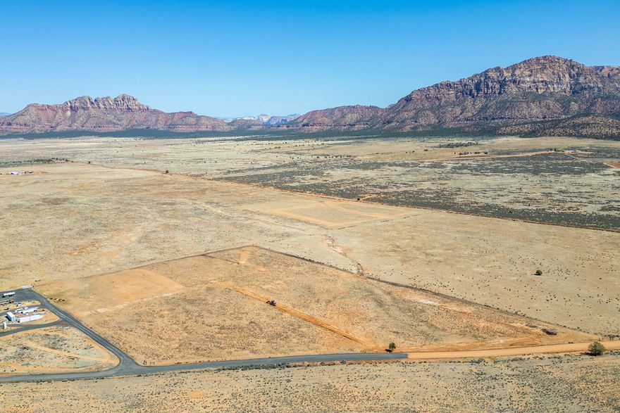 Escape to the serenity of Apple Valley with this stunning parcel just shy of 14 acres, offering wide-open space, breathtaking mountain views, and endless possibilities. Nestled in a peaceful and private setting, this expansive property is perfect for those seeking a quiet retreat with room to grow. Currently zoned Agricultural and falling within the Greenbelt, this land offers significant potential for lower property taxes. Enjoy easy year-round access and the convenience of your very own private well already in place. With a successful closing, the seller is ready to bring power and fiber directly to the lot—making it ready for your dream home, ranch, or recreational getaway. Marvel at the panoramic red rock vistas and star-filled skies at night, all while being just a short drive from local amenities, Zion National Park, and surrounding outdoor adventures.