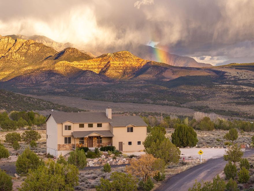 Views, Views, Views! Looking for a rural gem that offers space with peace and quiet plus acreage. This rare find is located on 4 acres with stunning unobstructed views of Pine Valley Mountain from a new large back deck. Embrace the epic sunsets from your front porch. Cozy wood fireplace, cherry wood floors, granite counter tops, hand-hewn maple cabinets. 5 bed/3 bath, 2 family rooms, plus a walk out finished basement with flex room and more.  Only minutes from town but away from all the hustle & noise. Build your dream shop/garage or separate dwelling for guests. Horse property plus other animals allowed. No HOA. Propane & newer septic tank. Close to riding trails, fishing, Veyo pool, Gunlock reservoir, Snow Canyon Sate Park, & Pine Valley.