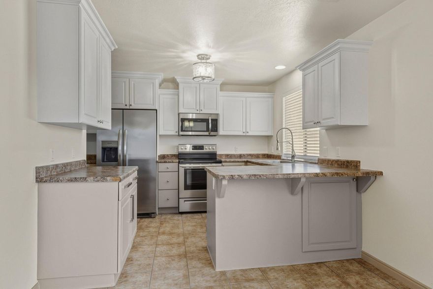 Updated Townhome with Private Backyard. This two-level townhome offers a perfect layout with clearly defined living spaces and practical features throughout. The main level includes an interior entry, living room, dining area, kitchen, laundry room, pantry and a half bathroom, creating an efficient flow for daily use. The kitchen includes a new sink and appliances, including a dishwasher, stove, and refrigerator. Tile flooring is featured on the main level, with carpeted living areas and upper-level bedrooms. Upstairs features the oversized primary en-suite bedroom with two additional bedrooms and a second full bathroom. Storage is integrated throughout the home, and ceiling fans are present in several rooms. The exterior includes a private backyard space and assigned covered parking plus an extra space per unit. The property is located near local shopping, dining, the community center and easy access to the freeway providing convenience for everyday living.