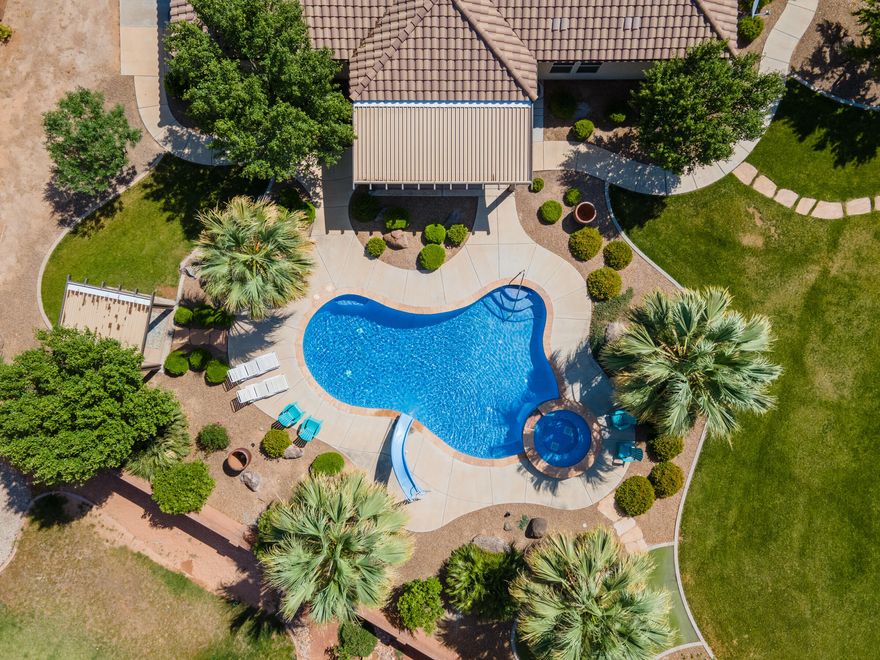 This home has it all!! Backyard paradise! Relaxing atmosphere inside and out, pool with slide, hot tub, putting green, horseshoe pit, basketball court, pergola, large covered back patio. Over ½ an acres with space to build a detached garage/casita or RV parking. Beautiful landscaping with palm trees, fruit trees, garden area, very nice stucco hobby shed with tile roof. Amazing views of the mountains & the Red Cliffs Edifice in a gated community. Superb location near excellent schools. Excellent floor plan, huge storage room off kitchen, epoxy garage floors, extra deep 3rd car garage and so much more. Occupied, shown by appointment only. *All information is deemed reliable but not guaranteed, buyer to verify all.