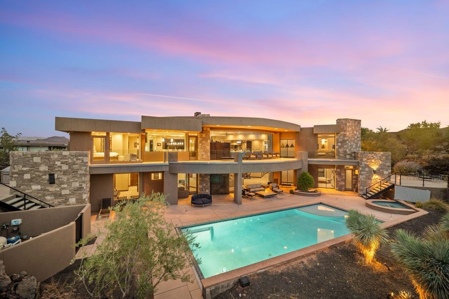 Welcome to your private desert sanctuary nestled in the heart of the prestigious Entrada at Snow Canyon Country Club. This one-of-a-kind estate sits on a rare 2-acre golf course lot and offers over 7,000 square feet of luxury living, designed to embrace the natural beauty of Southern Utah while delivering unparalleled comfort and sophistication.

From the moment you arrive, you're greeted with panoramic, unobstructed views of Snow Canyon, creating a truly breathtaking backdrop that seamlessly blends indoor and outdoor living. Thoughtfully positioned to maximize privacy and scenery, this architectural masterpiece boasts an open-concept layout, soaring ceilings, and walls of glass that invite natural light and red rock vistas into every room. The gourmet chef's kitchen is the heart of the home, outfitted with top-of-the-line Sub-Zero and Wolf appliances, custom cabinetry, and an oversized island perfect for entertaining. Flowing effortlessly from the kitchen is a spacious great room with a sleek fireplace and retractable glass walls that open to an expansive outdoor living area.

Step outside to your personal resort, featuring a custom-designed swimming pool, spa, outdoor kitchen, and shaded patiosall overlooking the golf course and framed by the awe-inspiring cliffs of Snow Canyon.

Inside, the home offers 5+ bedrooms, multiple en-suite baths, private office, and a state-of-the-art indoor basketball courta rare amenity that elevates this home into a league of its own. The expansive primary suite includes a spa-inspired bath, dual closets, and private terrace access with sunrise and sunset views that are nothing short of spectacular.

This is more than a homeit's a lifestyle. Located in the guard-gated Entrada community, residents enjoy exclusive access to championship golf, fine dining, fitness facilities, and the serene desert landscapes that make this region a world-class destination.

Schedule your private tour today and experience luxury living at its finest in Entrada @ Snow Canyon.