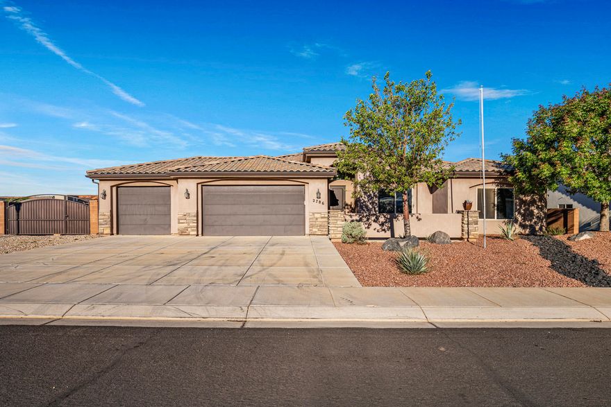 Enjoy the perfect blend of location, comfort, and views in this beautifully updated home near Dixie Springs Park, just minutes from Sand Hollow and Quail Creek Reservoirs. With fresh paint and new carpet, it's move-in ready and easy to love.

The functional split floor plan offers both privacy and flow, with a spacious family room centered around a cozy fireplace. The kitchen provides ample storage and flows seamlessly to the main living areas, perfect for everyday living and entertaining.

The primary suite features a large walk-in closet and a well-appointed bathroom with a generous walk-in shower.

Step outside to an expansive covered patio and take in stunning Pine Valley Mountain views. The property also offers a 3-car garage and plenty of gated RV parking for all your toys.

Permanent holiday lighting adds year-round convenience and curb appeal.

This home checks all the boxes- location, views, updates, and space for all your needs.
