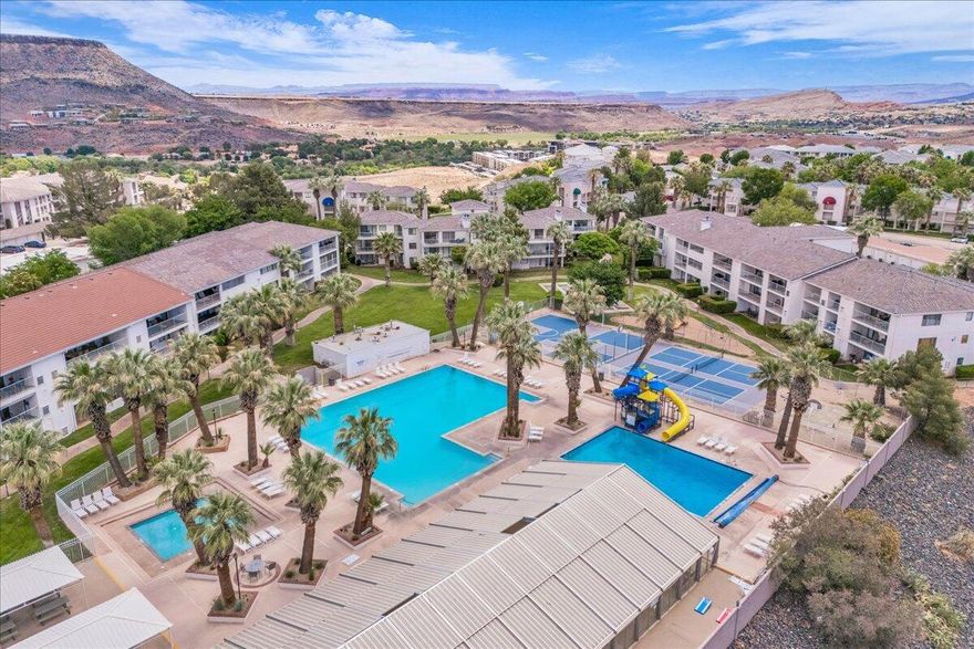 Zoned for nightly and weekly rentals and sold fully furnished with high-quality furniture, this spacious ground-floor end unit at Las Palmas Resort is the perfect getaway in sunny St. George! Las Palmas offers some of the best amenities around, including 5 outdoor pools, a year-round heated indoor pool, hot tubs, water slides, splash pad, pickleball & basketball courts, playgrounds, and a clubhouse with fitness center. This desirable end unit provides extra privacy, abundant natural light, and a large grassy area just outside the door. Relax on the extra-large back patio, providing dining space for 19, and take in the sweeping mountain and valley views--a perfect spot for entertaining. With room to sleep 9 plus a baby (there's a pack 'n' play ready!), there's plenty of space for everyone to stay comfortably. Inside, the spacious open floor plan creates a comfortable flow for gatherings and everyday living. Beautifully maintained and primarily used for owner enjoyment, this condo is move-in ready as your personal retreat or a strong vacation rental opportunity. Buyer/buyer's agent to verify all information.