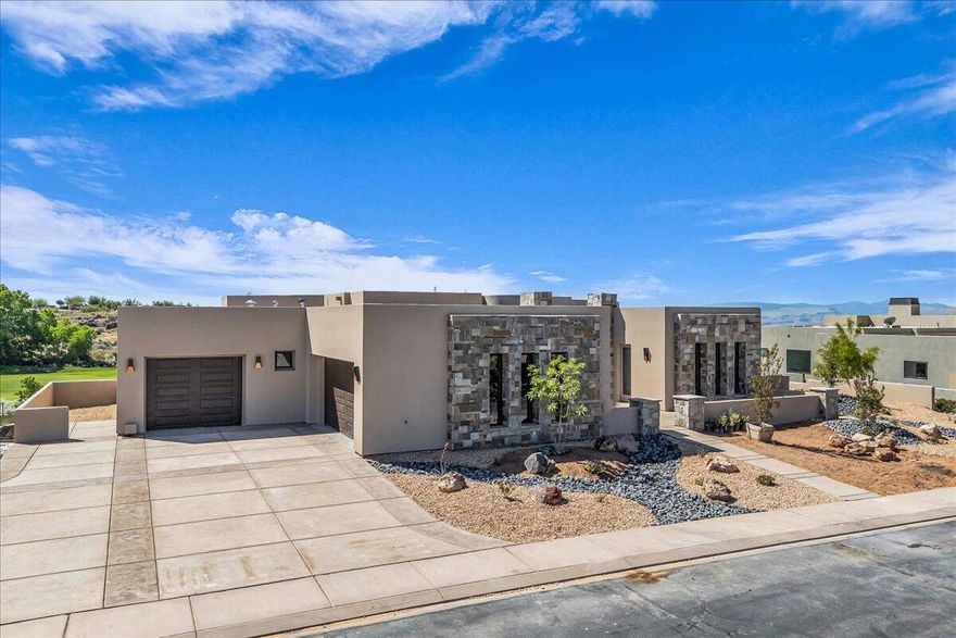 Newly built luxury home in The Ledges of St. George! This 6,074 SQFT custom build combines high-end craftsmanship with exceptional functionality. Featuring 5 spacious en-suite bedrooms, a chef's kitchen with top-tier appliances, granite countertops, and custom cabinetry, plus soaring ceilings and expansive windows with panoramic views of red rock cliffs and the championship golf course. The owner's suite includes a sitting area, spa-like bath with soaking tub, dual vanities, and walk-in closets. Additional highlights include a dedicated dining area, oversized laundry room, and 3-car garage. Enjoy a private pool with integrated spa and custom cover, a full-size pickleball court, fire pit, and seamless indoor-outdoor living—all in a secure, gated golf community near Snow Canyon.